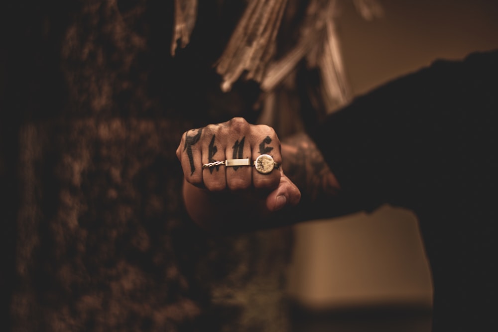 man wearing three rings