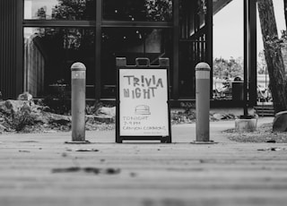 grayscale photography of Trivia night signage