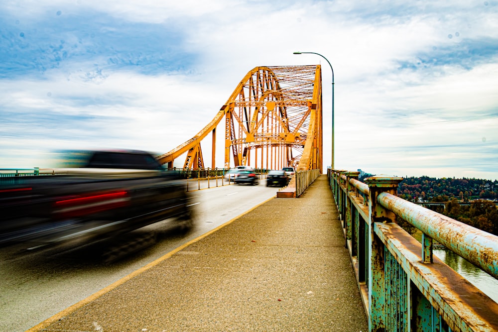 vehicles on road bridge during day