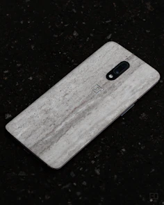 Close-up of a sleek phone back cover with a subtle matte finish and precise cutouts.