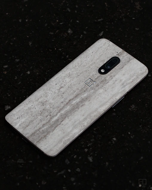 Close-up of a sleek phone back cover with a subtle matte finish and precise cutouts.
