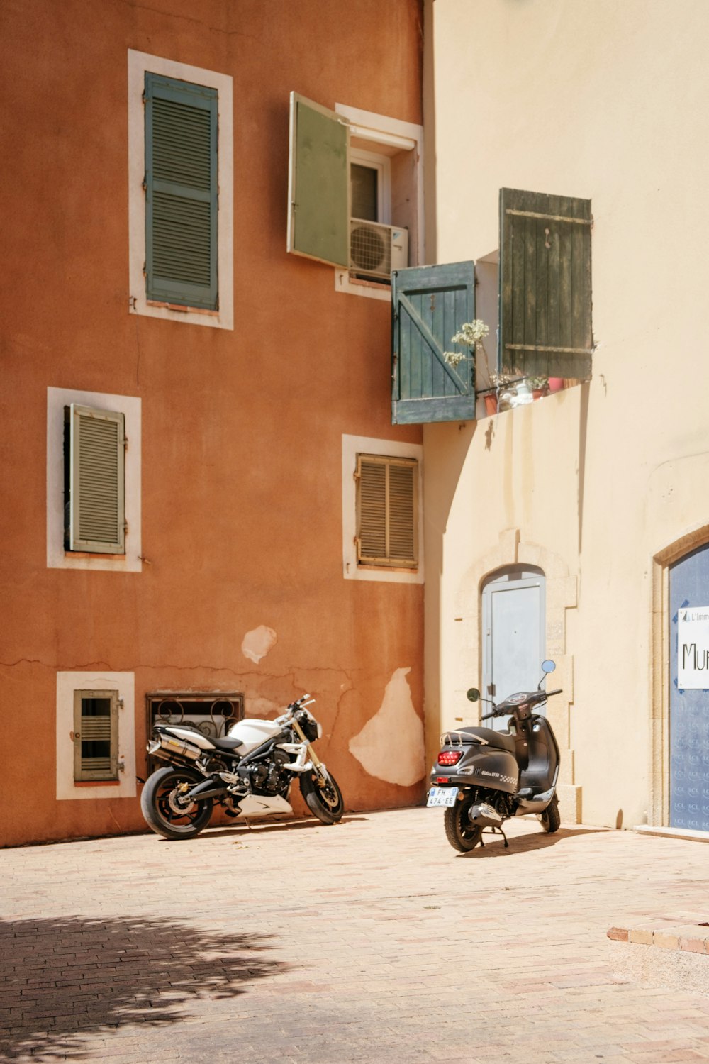 two motorcycles parked outside a building