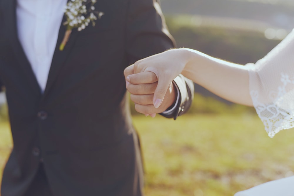 groom and bride holding hands