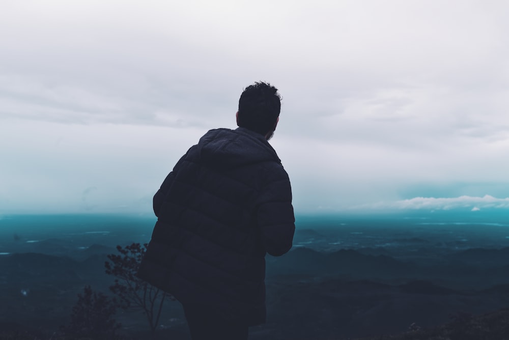 man wears black parka jacket