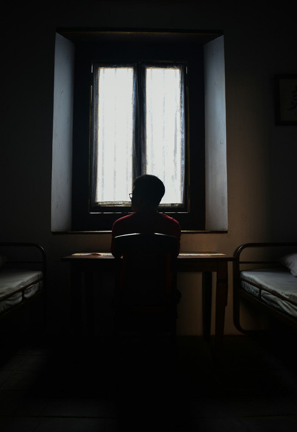 silhouette of person in front of window