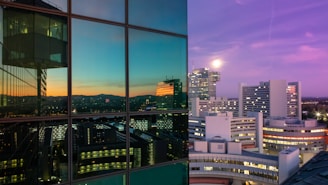 A modern Swiss city skyline with residential and commercial buildings at sunset.