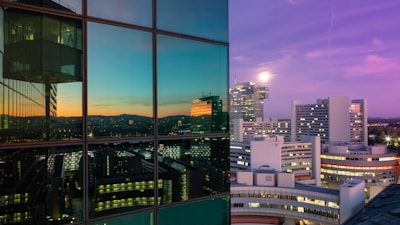 A modern Swiss city skyline with residential and commercial buildings at sunset.