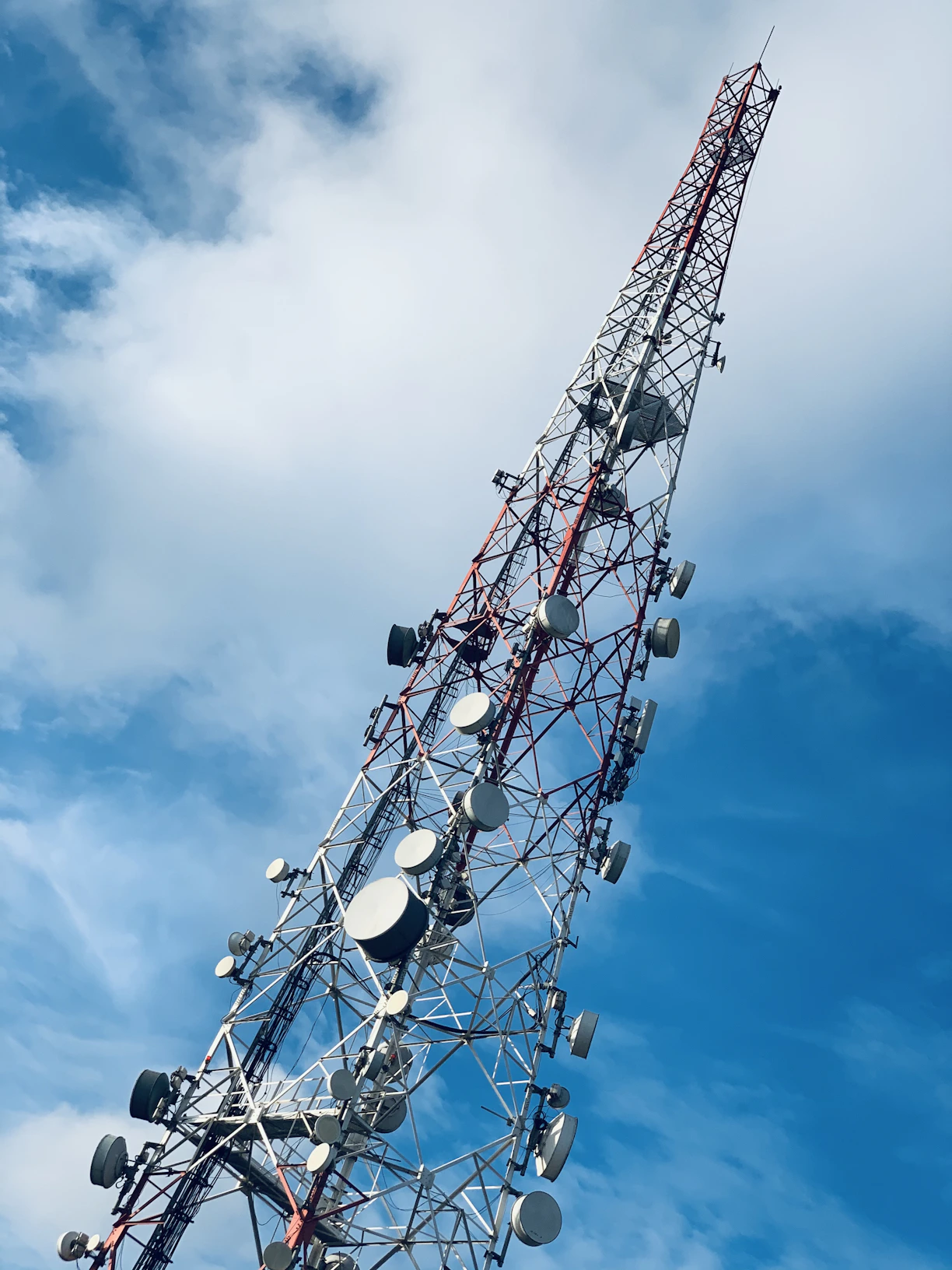 gray and red telecommunications tower