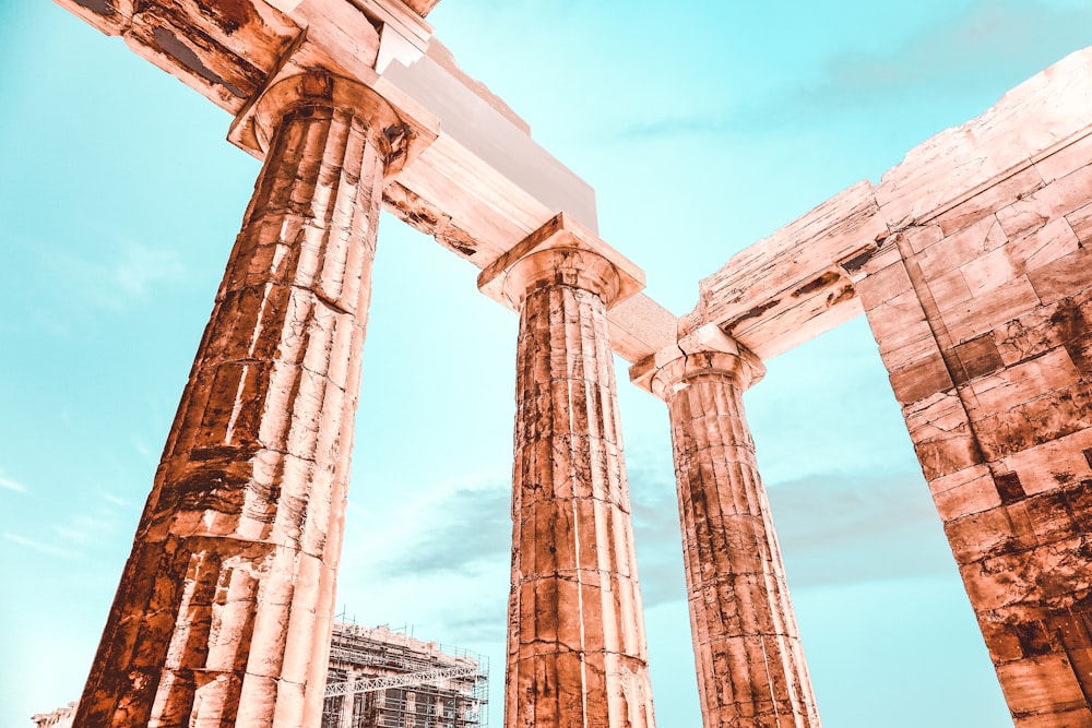 three brown concrete pillars