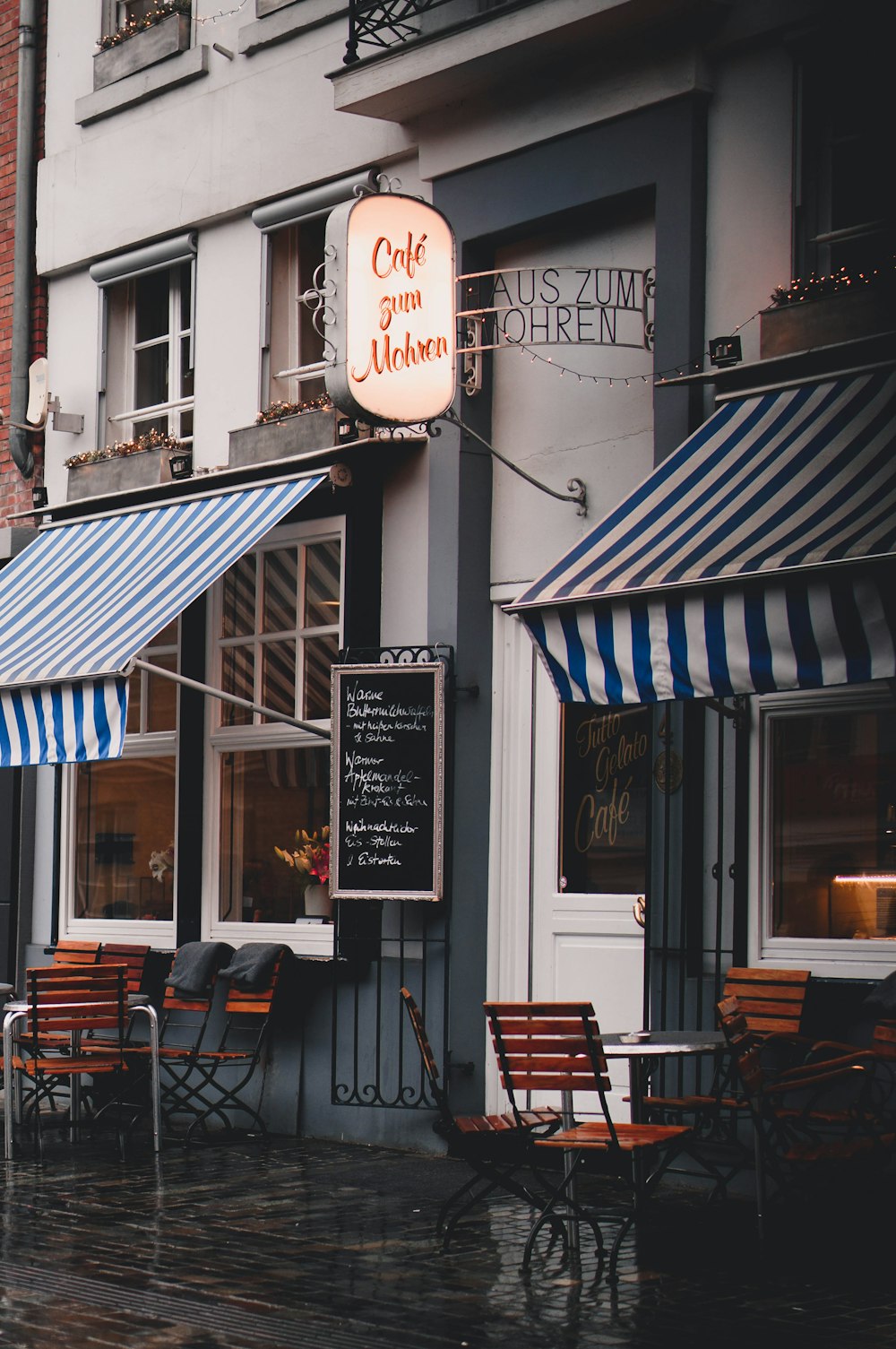 tables and chairs in front of cafe