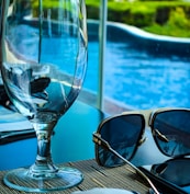 empty goblet beside sunglasses