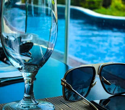 empty goblet beside sunglasses