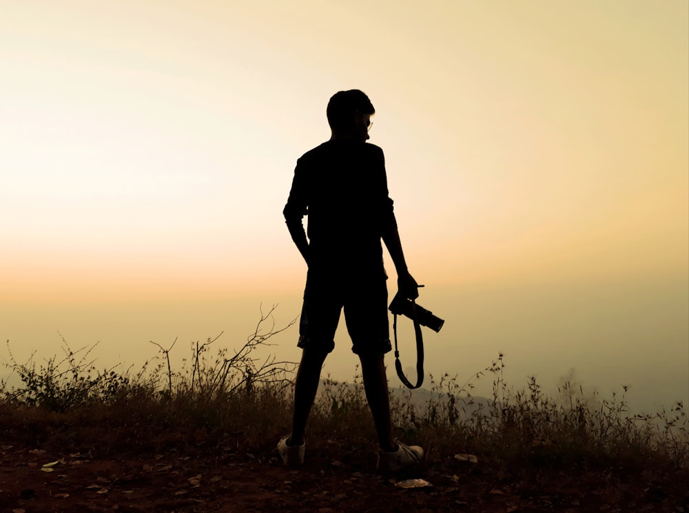 man holding DSLR camera