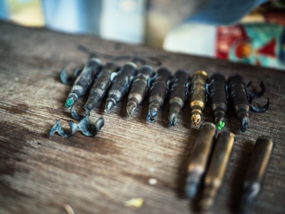 A selection of premium saltwater fishing hooks and swivels laid out on a wooden table.