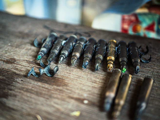 Assortment of fishing hooks and accessories laid out on rustic wood