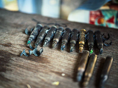 Assortment of fishing hooks and accessories laid out on rustic wood