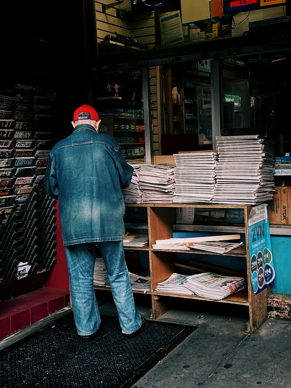 man wearing blue denim jacket and blue jeans