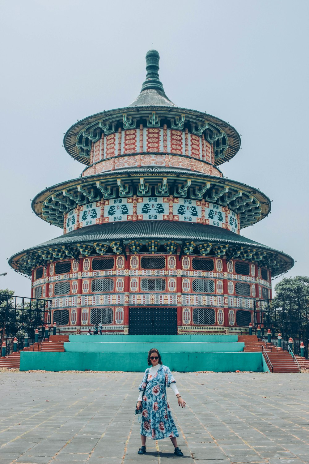 woman in front of white and red building during daytime