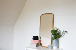 Minimalist white styling station featuring a large mirror and subtle gold details.