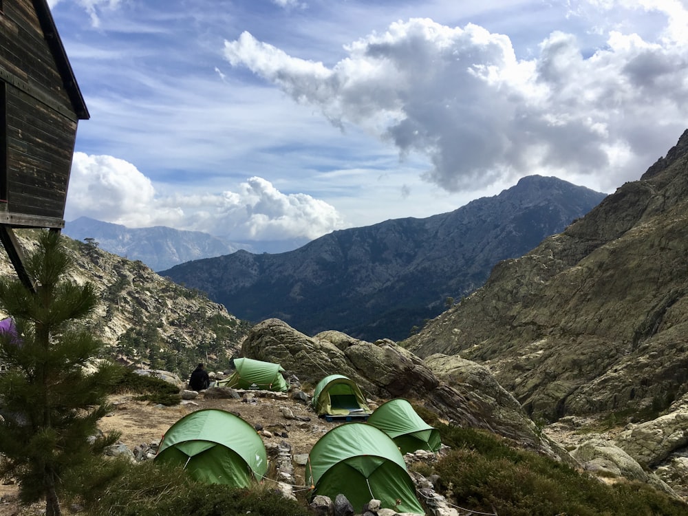 green tents on mountain during daytime