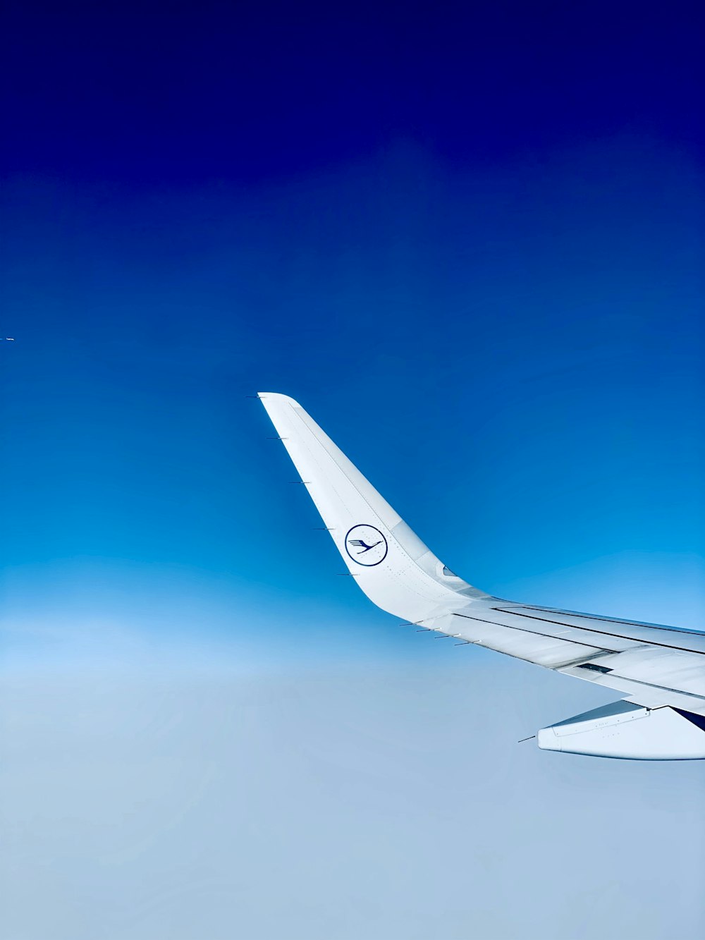 white and black Lufthansa airplane in the sky during daytime