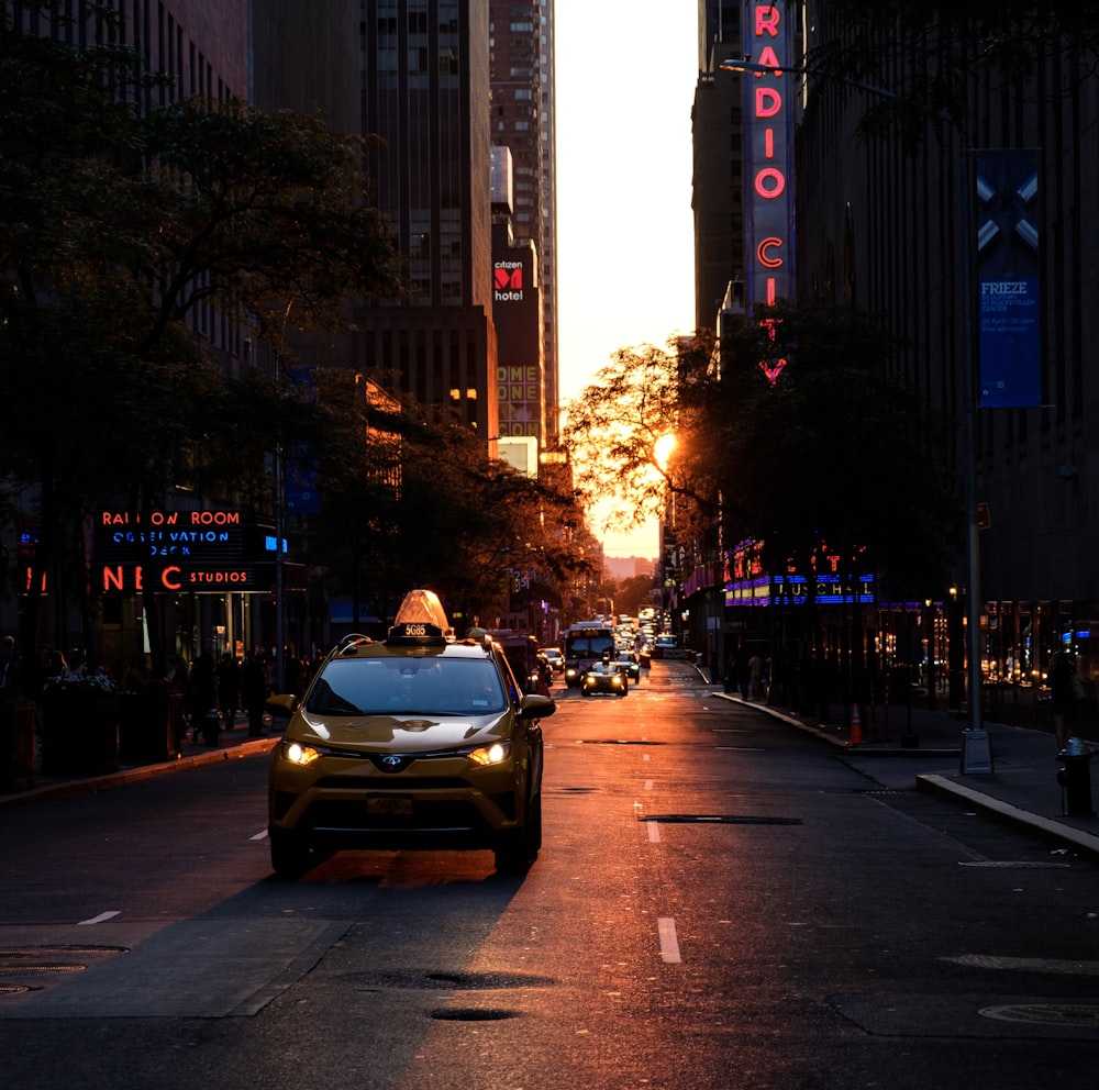 yellow taxi on road during sunset