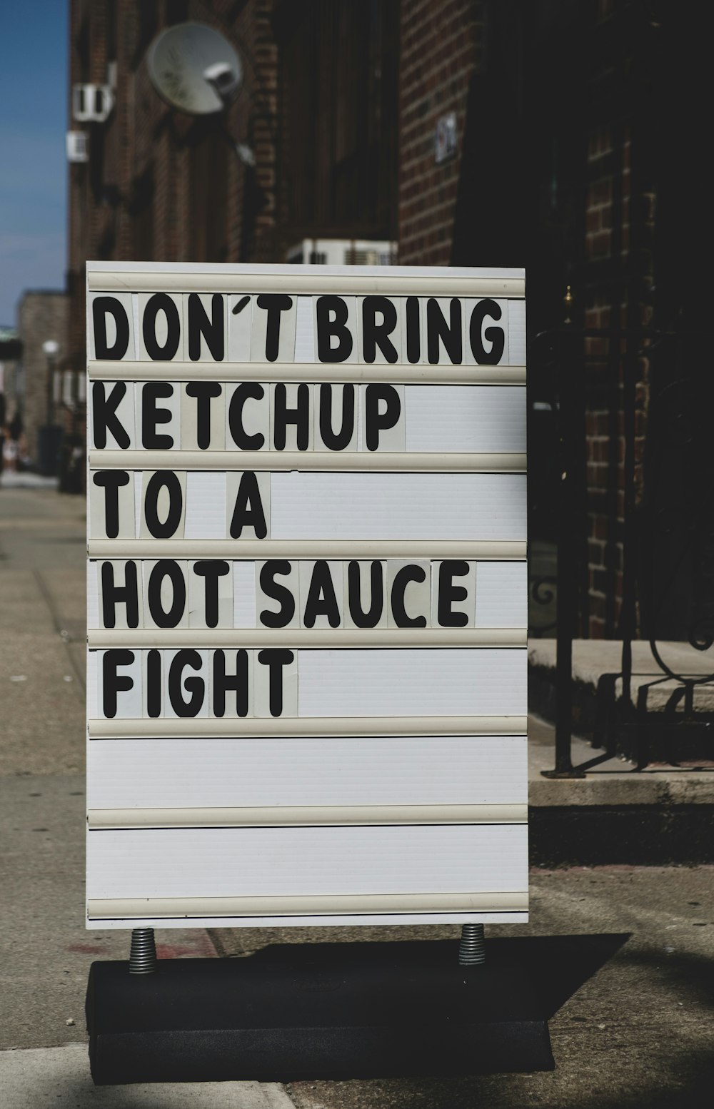 white board with don't bring ketchup to a hot sauce fight