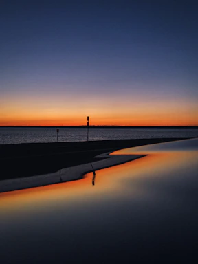 A calm, serene sunset behind a paused loading icon on a simple webpage
