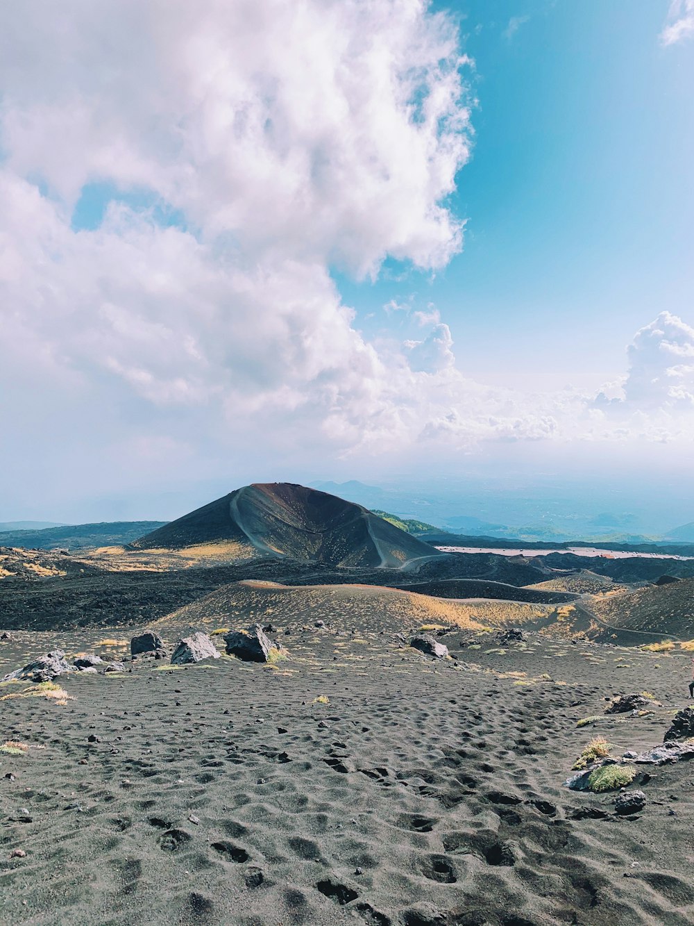 a view of a mountain range from the top of a hill