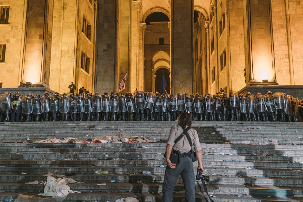 woman standing in front of group of police men