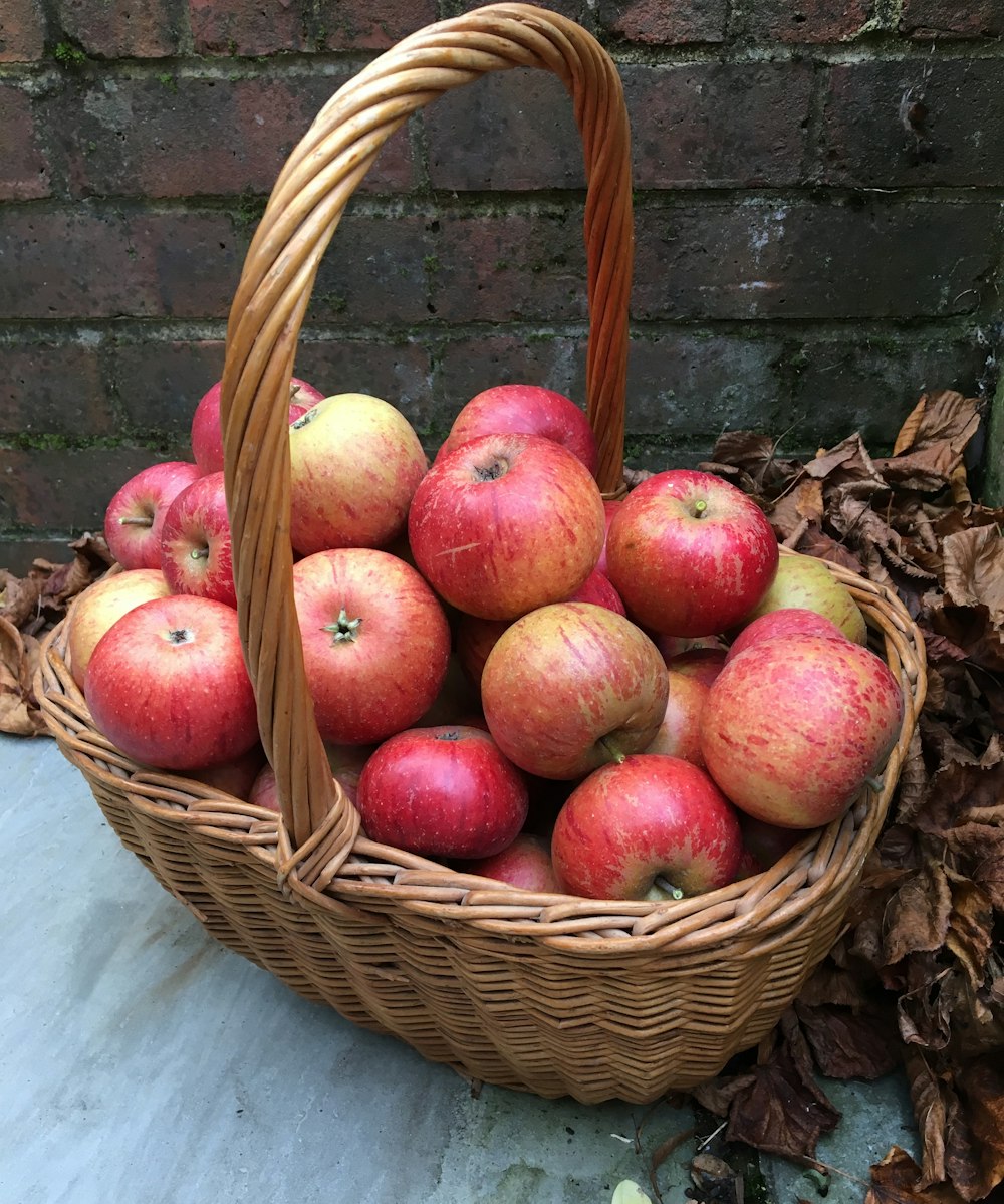 apple fruits in brown wicker basket