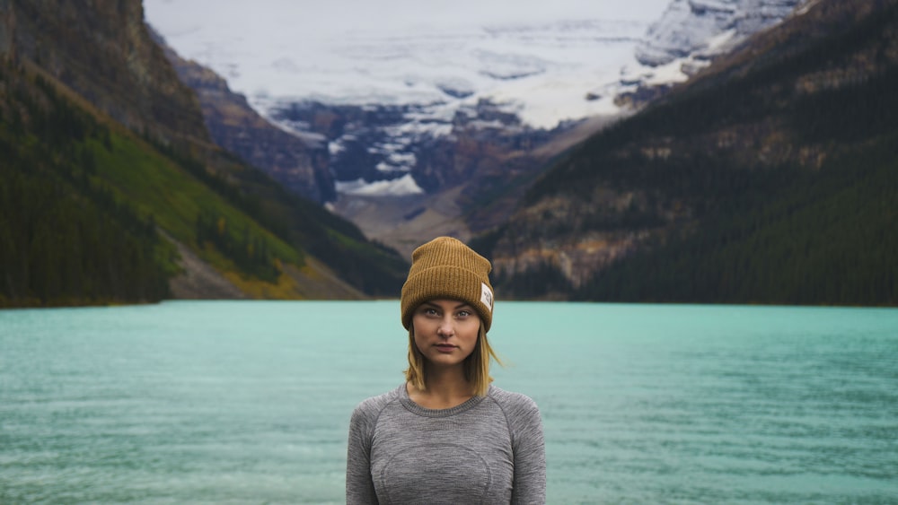 woman standing near calm ocean