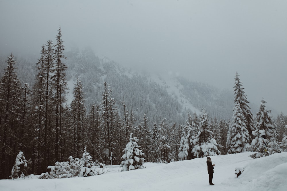 man standing on snow field at daytime