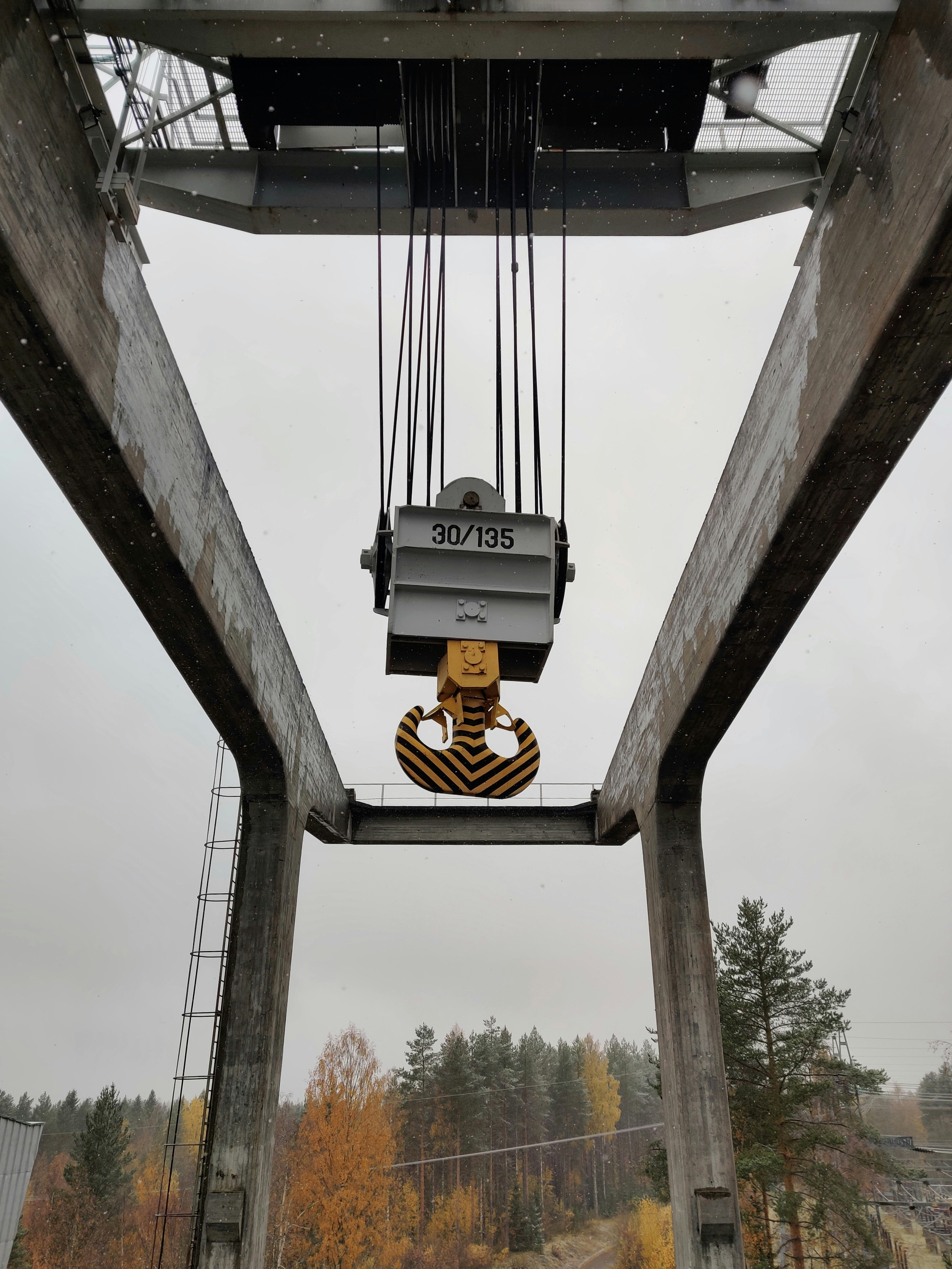 a crane is lifting a piece of wood into the air