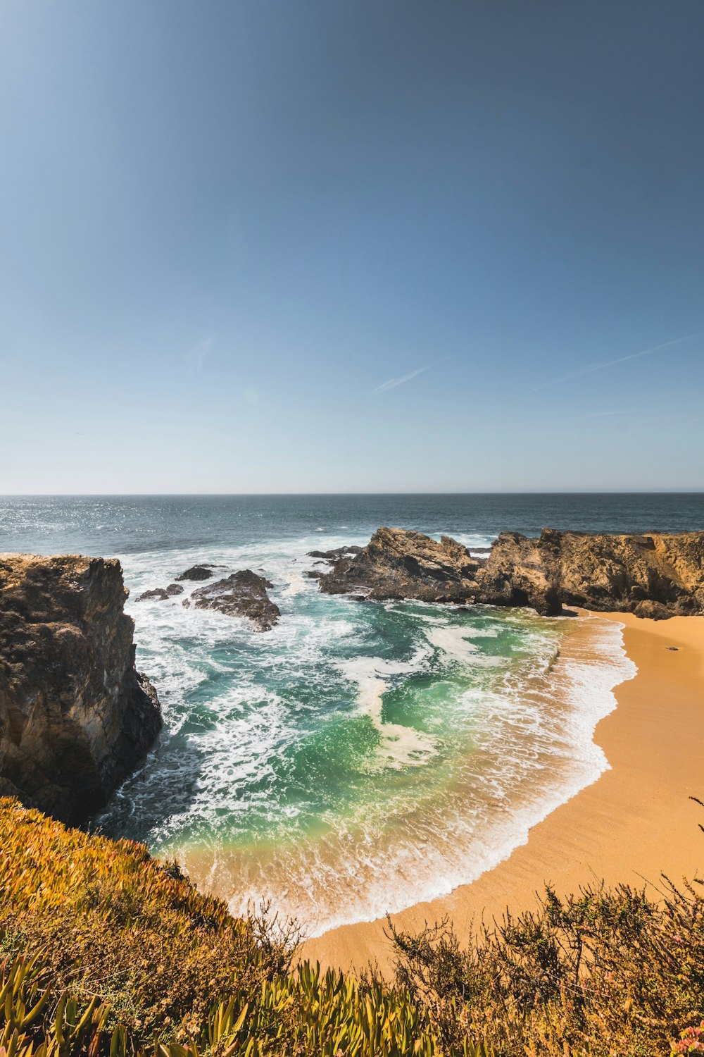 a view of the ocean from the top of a hill