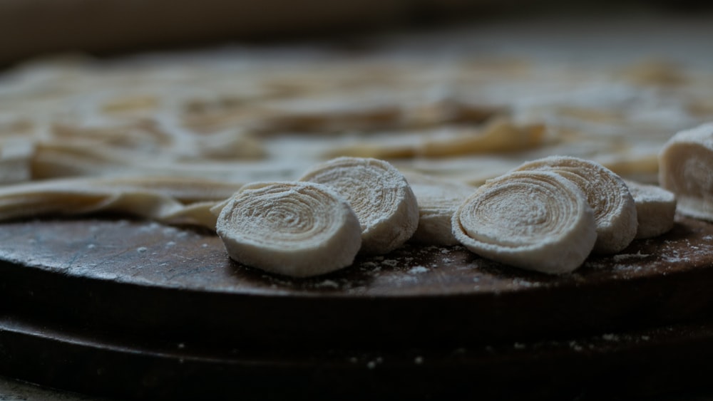 a wooden cutting board topped with sliced bananas