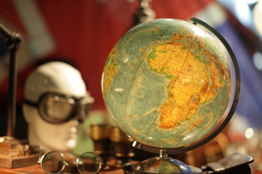 brown and blue globe sphere on table