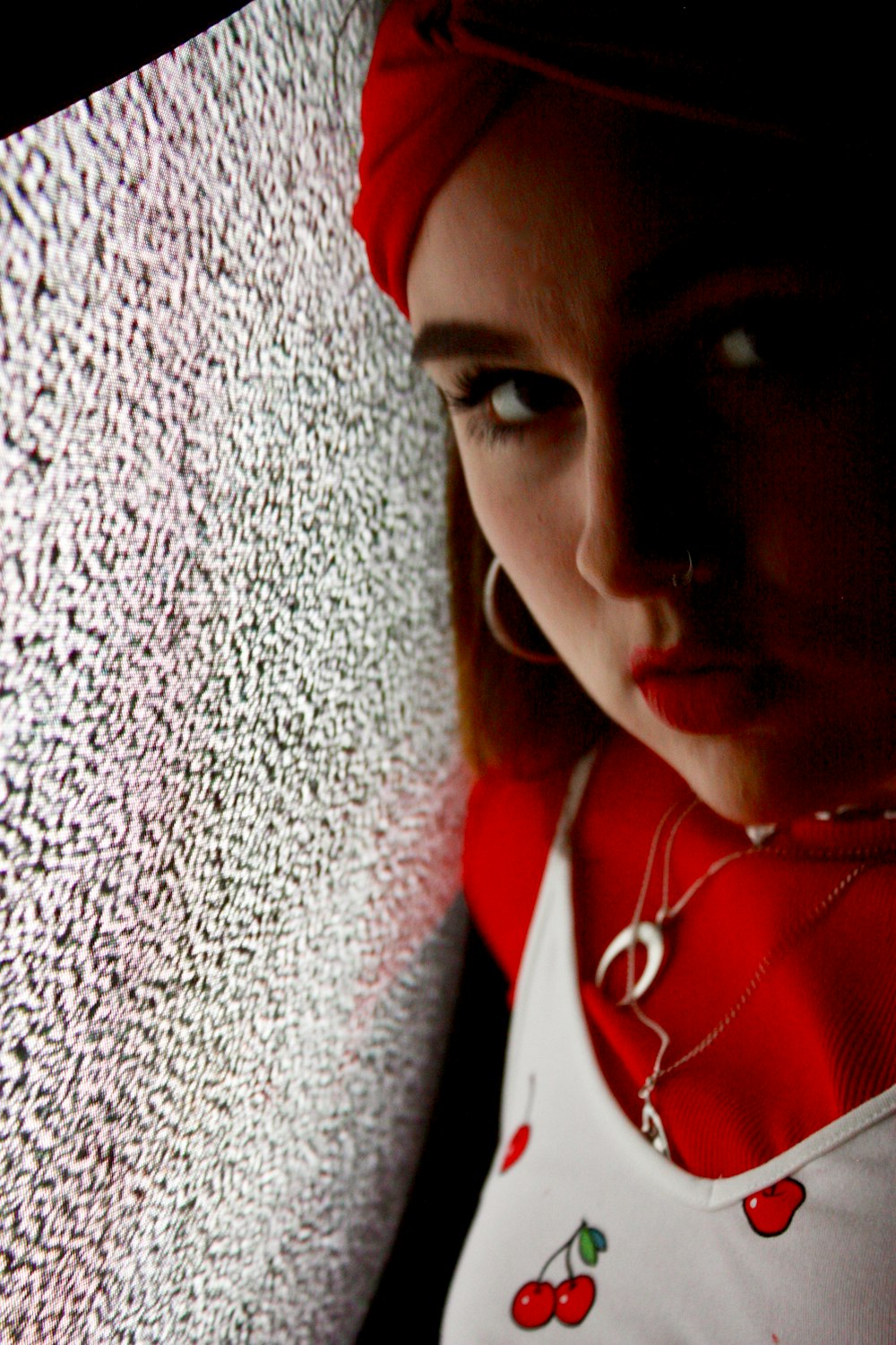 woman in red and white top facing by a CRT TV