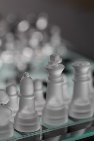 Single king chess piece standing alone on a board, endgame position