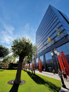 Completed office building with glass facade under clear sky.