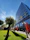 A well-maintained office building exterior with clear skies and warm sunlight.