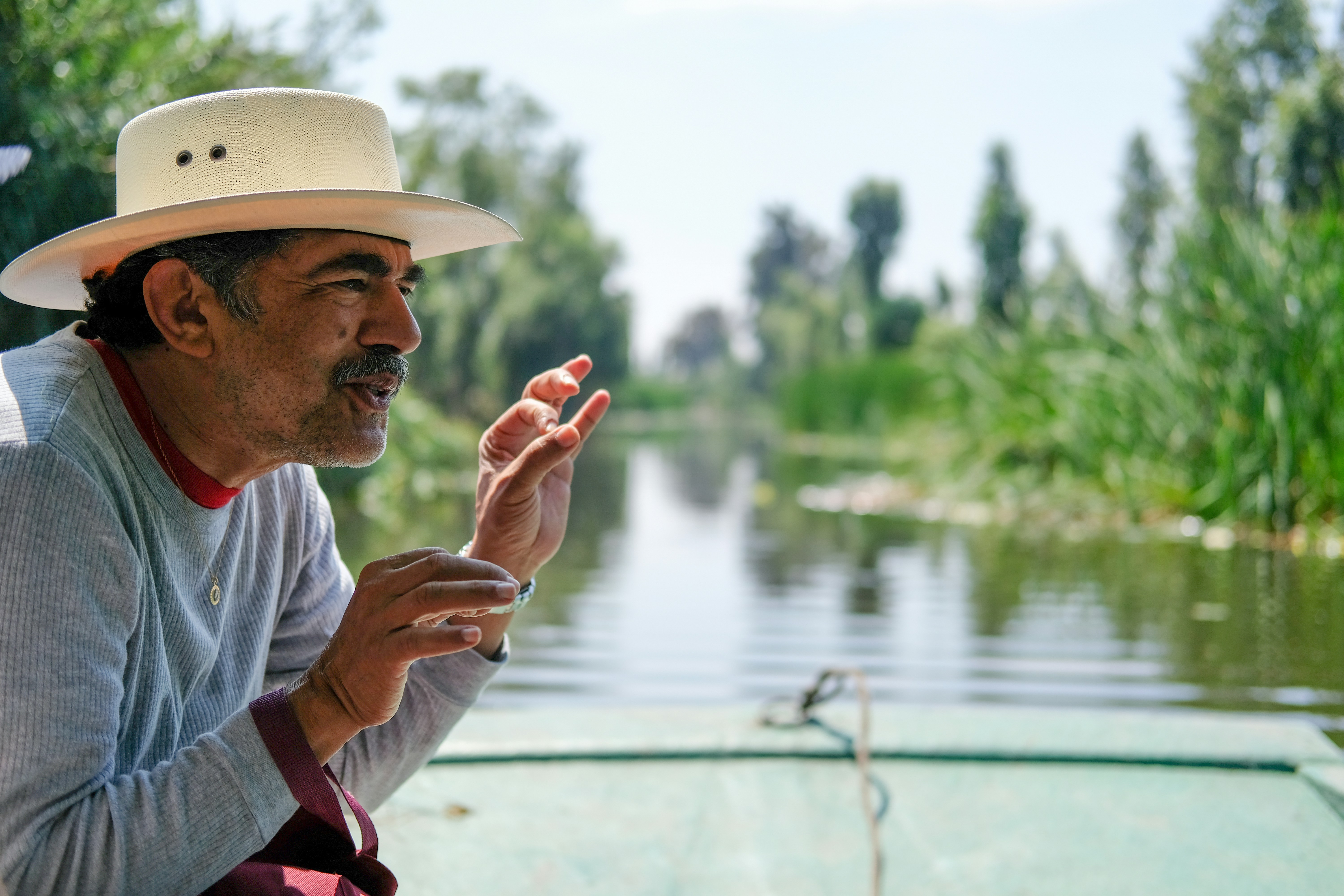 man on boat between trees