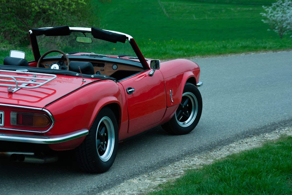 red Triumph Spitfire on road