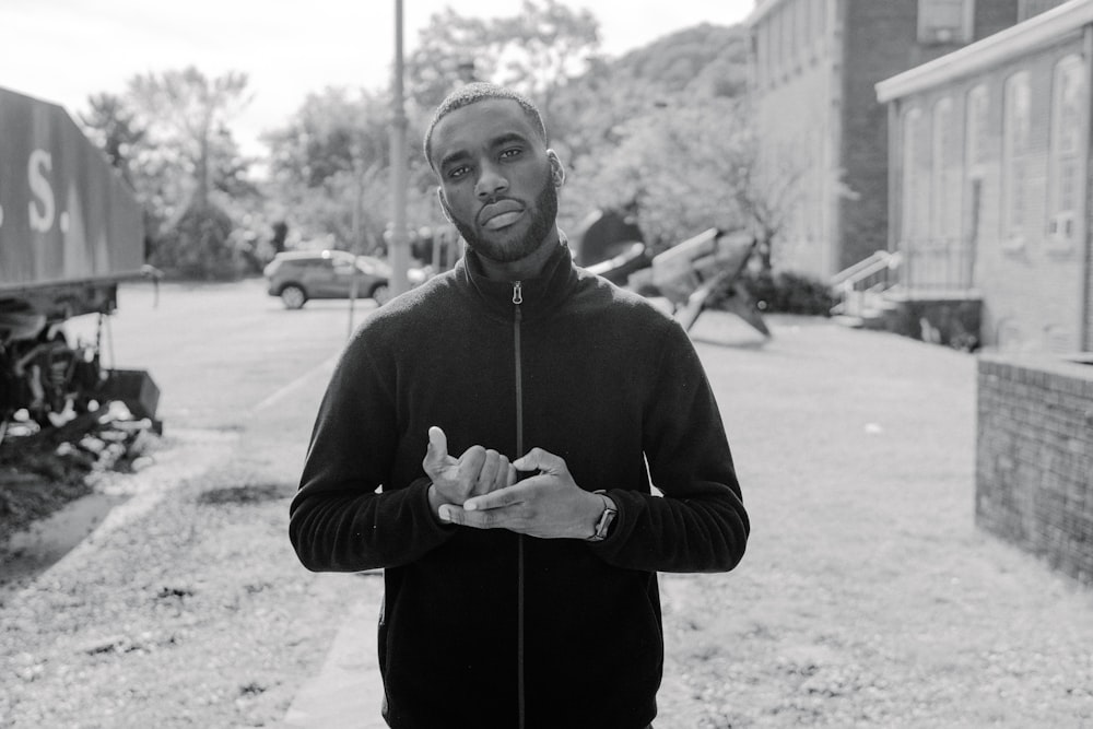 man wearing black zip-up jacket