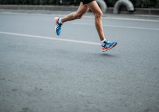 pair of blue-and-white Adidas running shoes