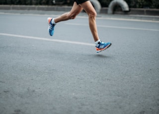 pair of blue-and-white Adidas running shoes