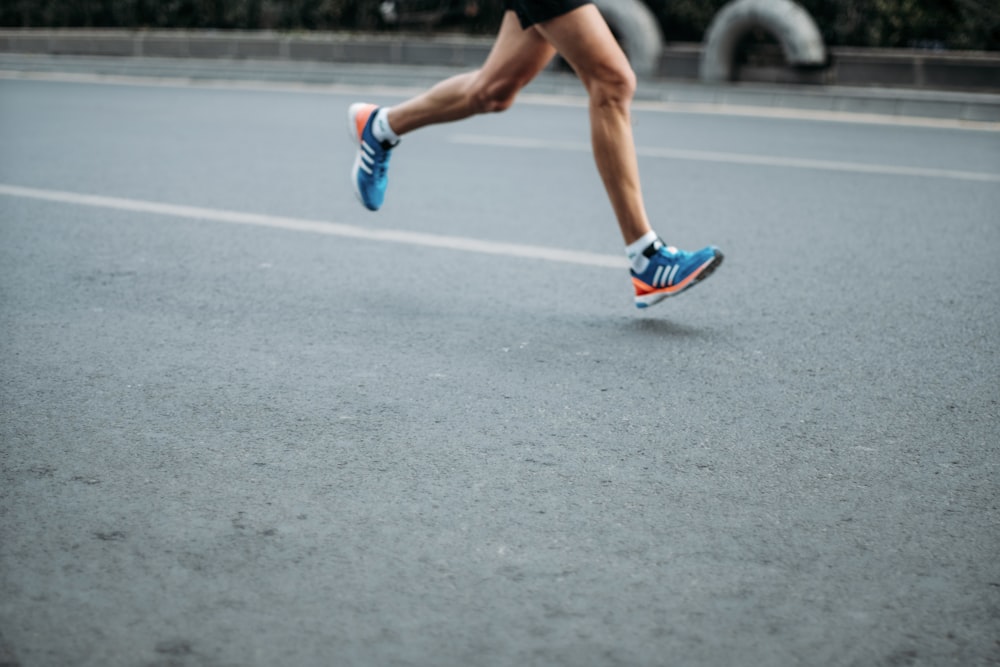 pair of blue-and-white Adidas running shoes