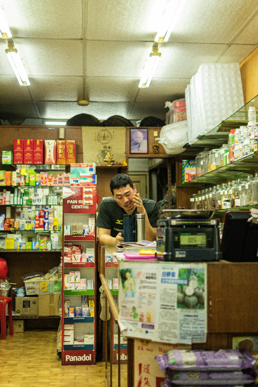 man wearing black shirt leaning on display counter