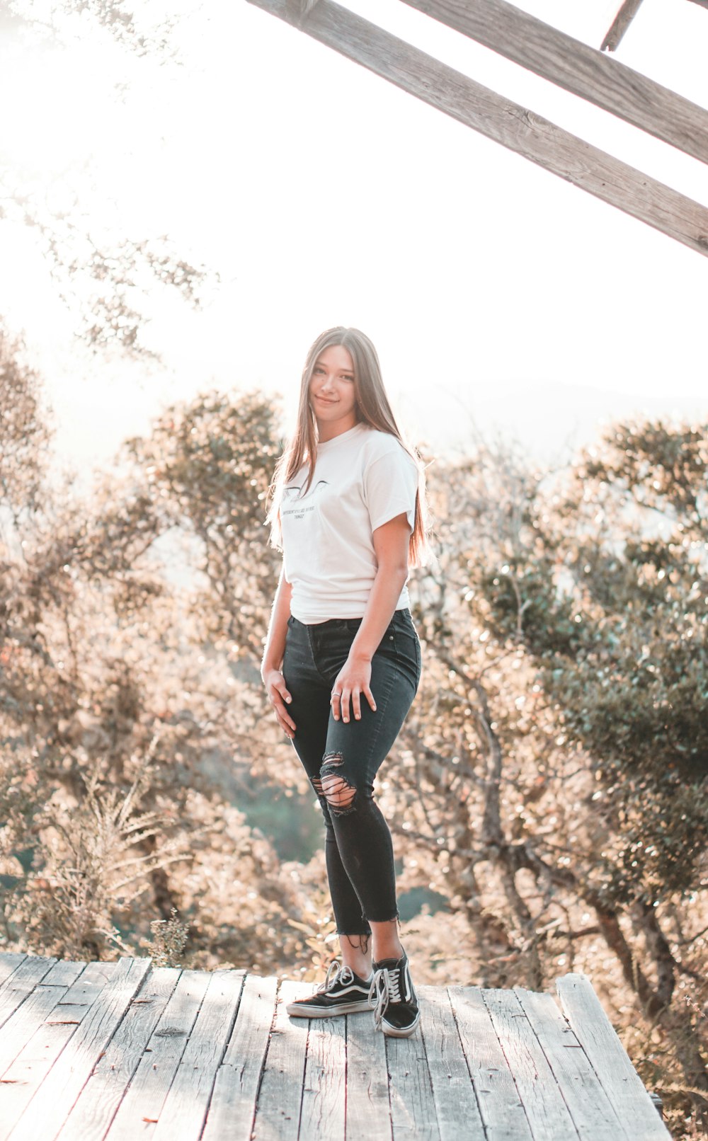 woman wearing white t-shirt and black pants