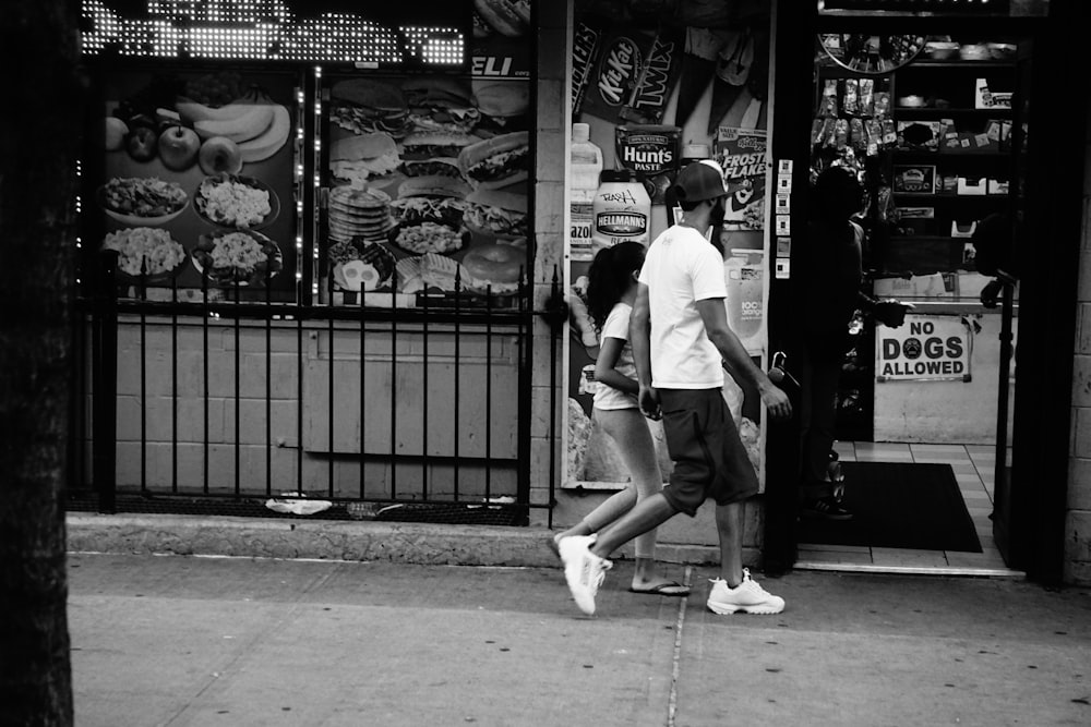 man and child walking on street